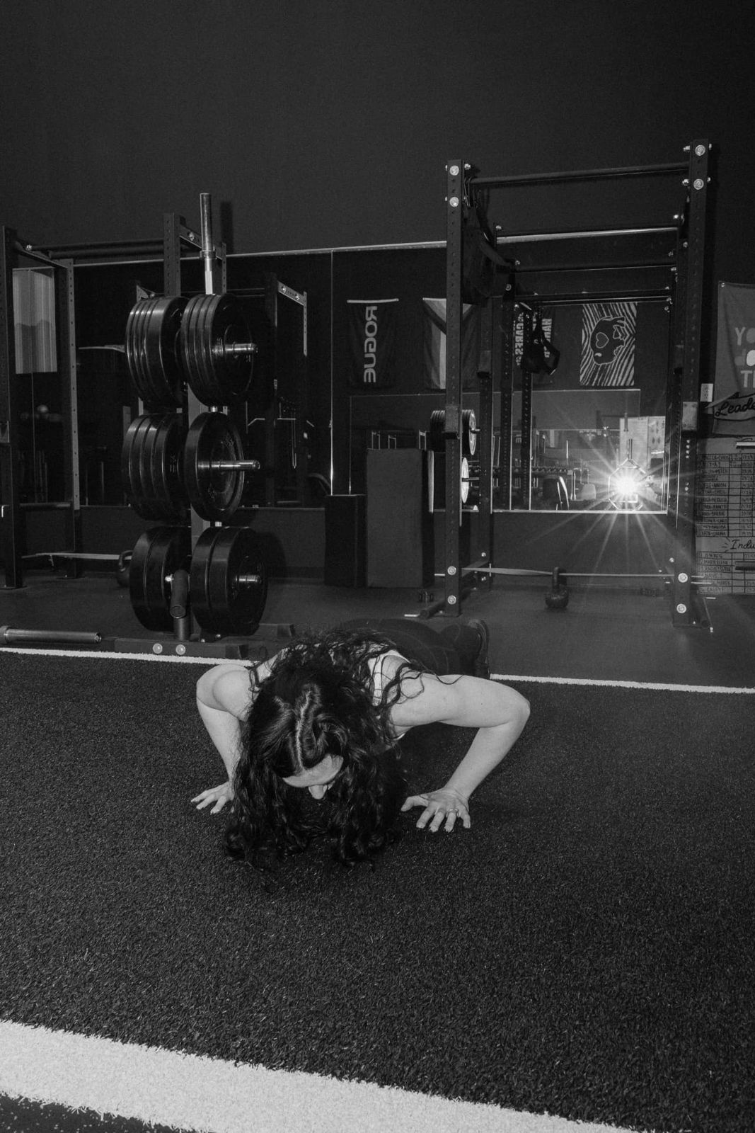 Black and white photo of a member training on the turf at RockeyFit